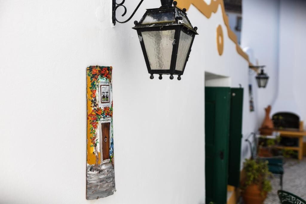 A wall-mounted light fixture and a decorative panel with a door illustration.