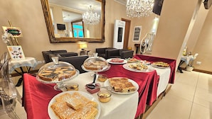 A dining table with various desserts and a mirror in the background. - La Castellana (Bergamo)