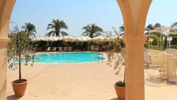 Piscine extérieure, parasols de plage, chaises longues