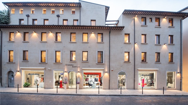 A building with multiple storefronts, including a visible sign for 'Di Sabatino Resort'.