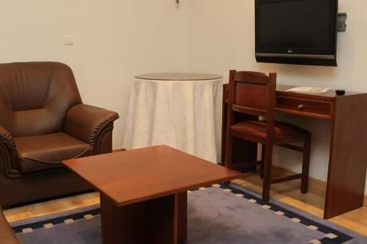 Quadruple Room | Living area | Flat-screen TV