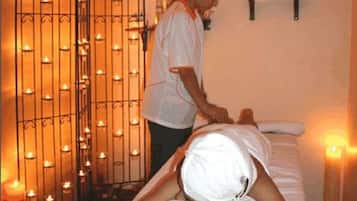 Experience a rejuvenating massage in a serene space, complete with a massage table and soothing ambiance.