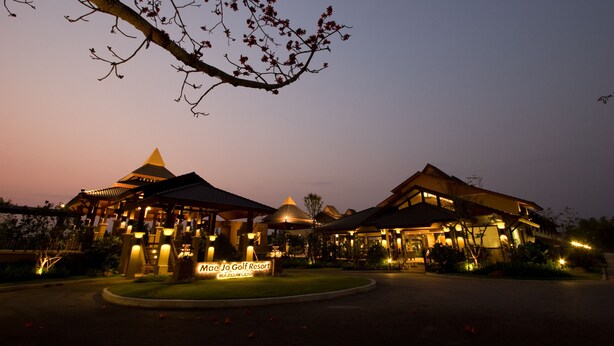 Mae Jo Golf Resort with traditional architecture, a signboard, and well-lit surroundings. - Mae Jo Golf Club & Resort (San Sai)