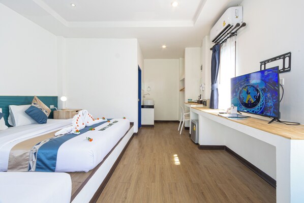 A hotel room with a bed, a desk, a television, and a bathroom visible in the background. - Three Trees Samui Resort - Sarocha Villa (Koh Samui)
