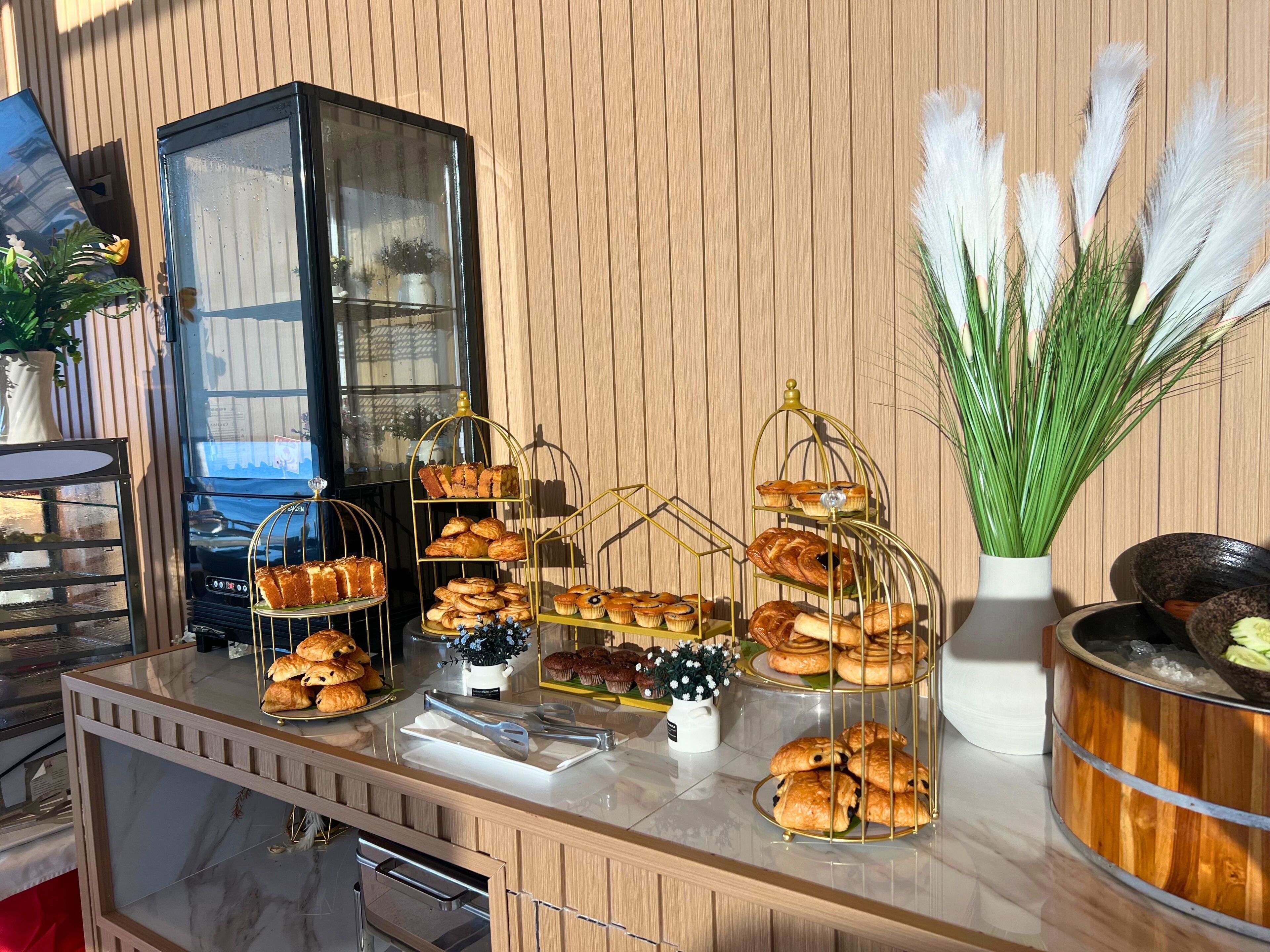 A bakery display with various pastries and a coffee machine.