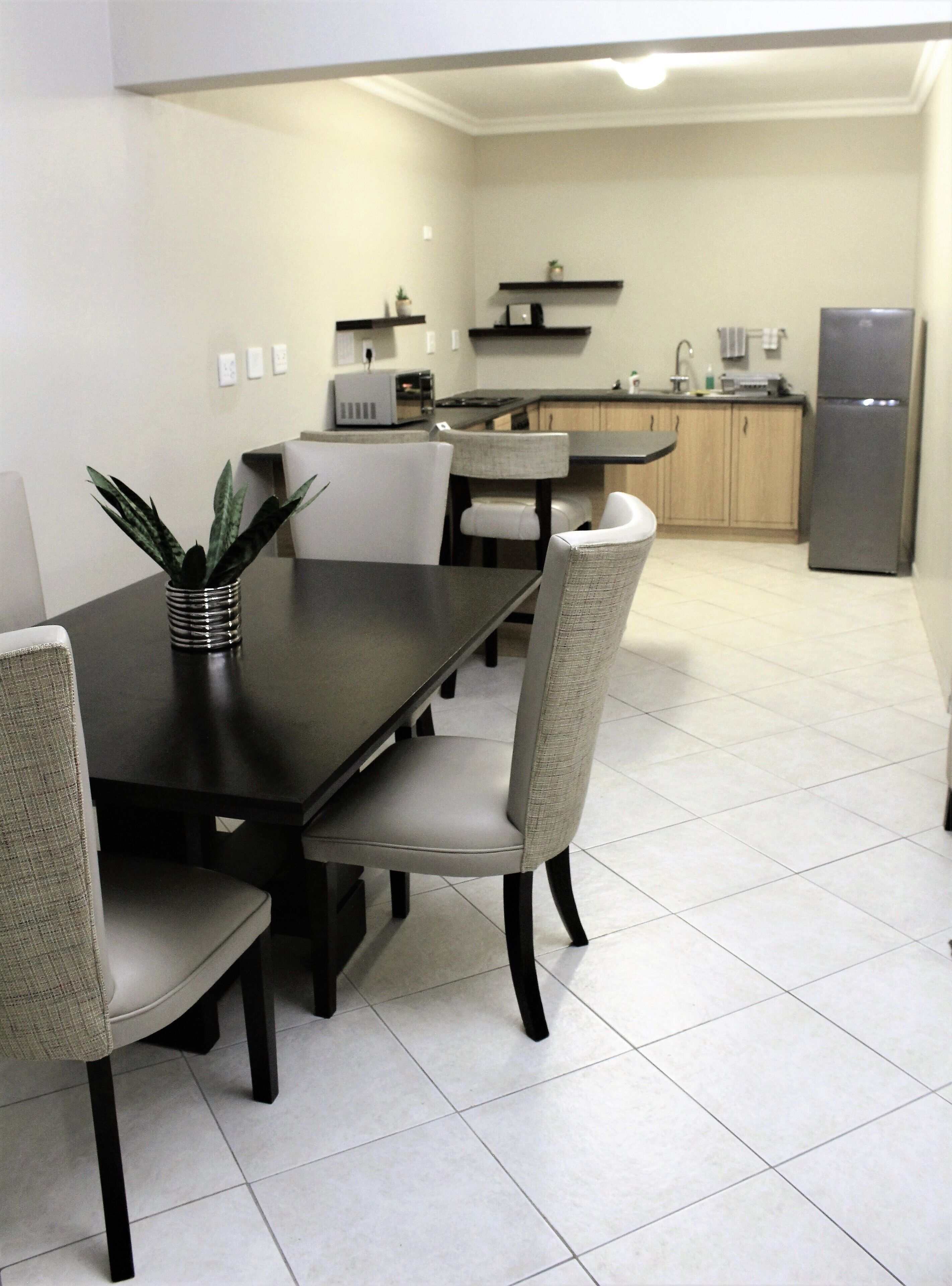 A modern kitchen with a dining area.