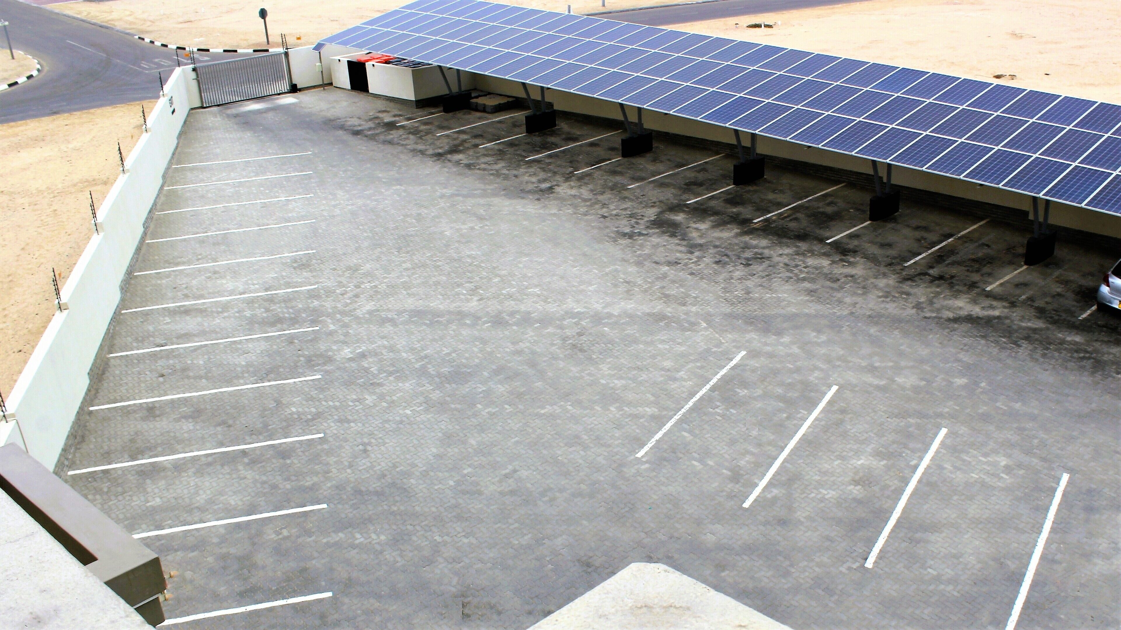 A parking lot with solar panels on the roof.