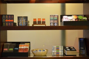 A shelf with various packaged items, including boxes and baskets, likely containing toiletries or small gifts.