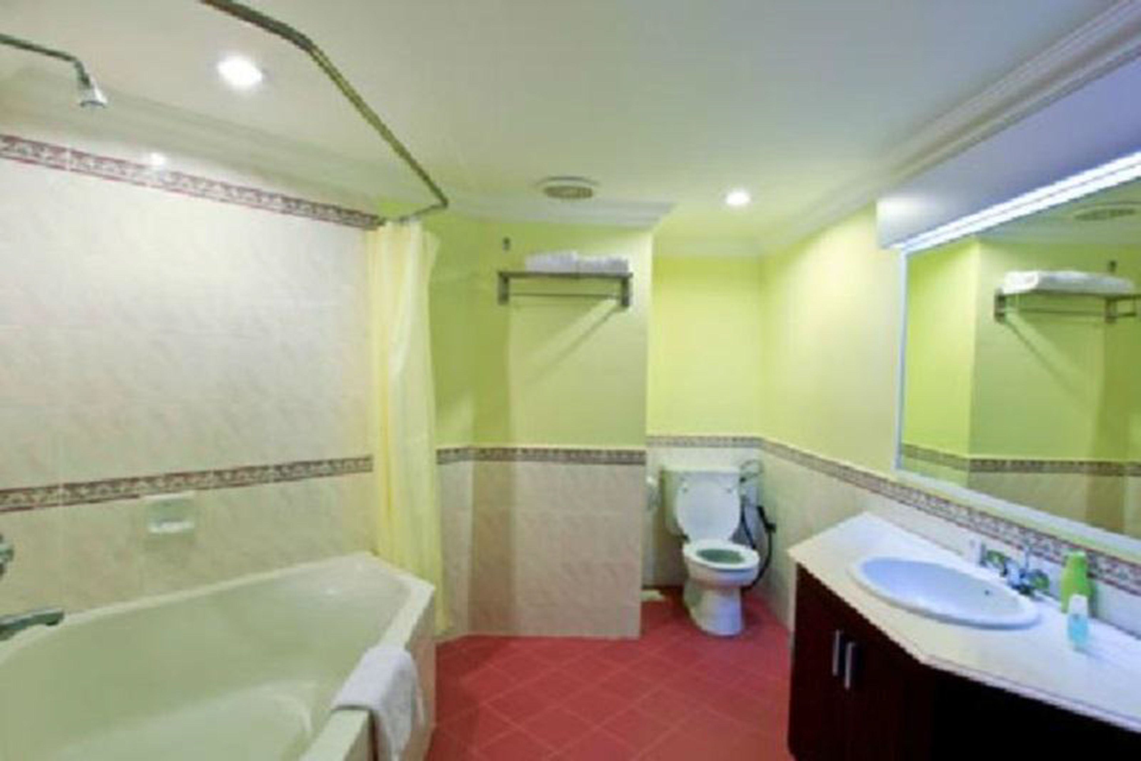 A bathroom with a bathtub, toilet, and sink.