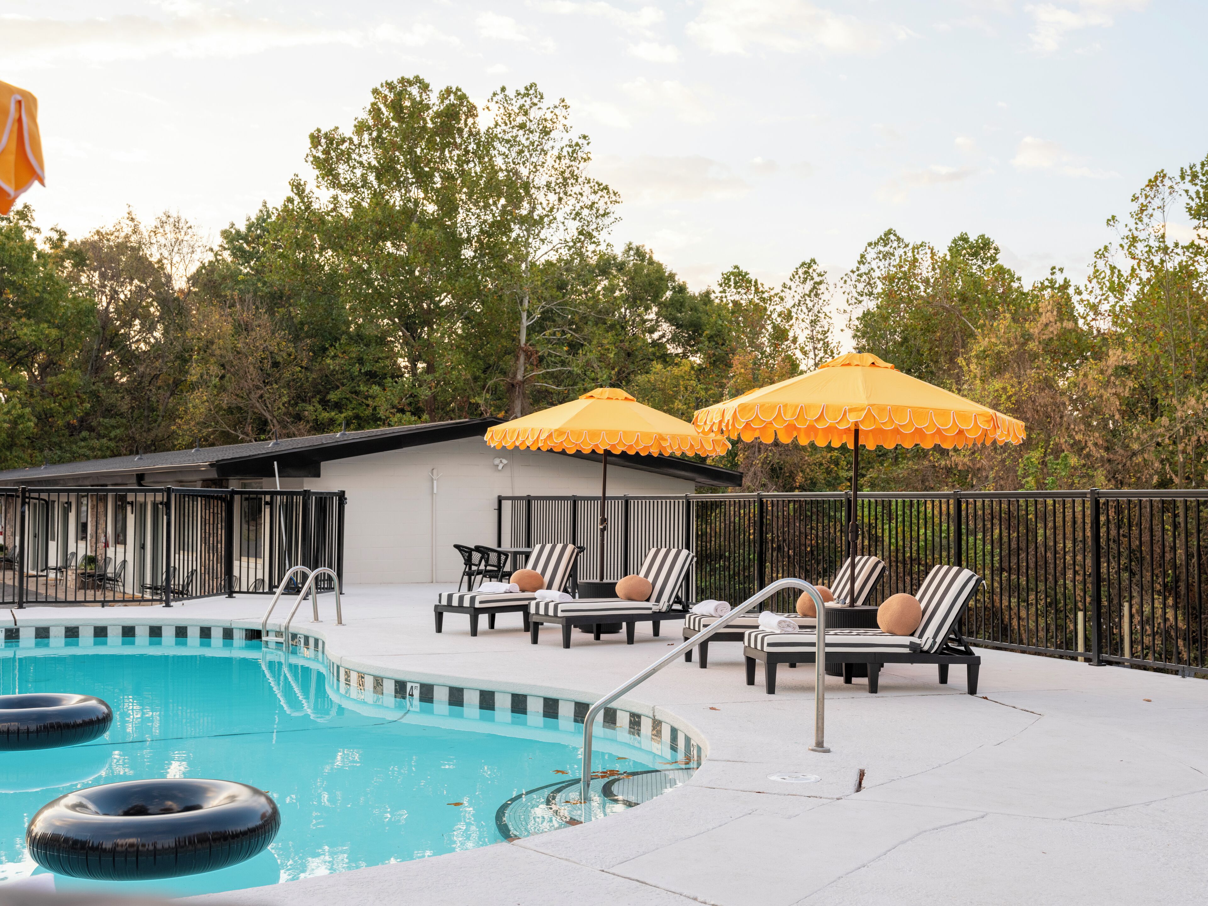 Seasonal outdoor pool, open 10:00 AM to 10:00 PM, pool umbrellas