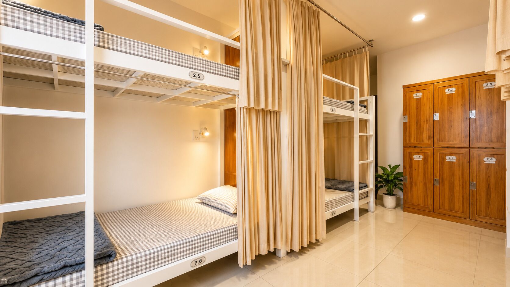 A dormitory room with bunk beds, wooden lockers, and a potted plant.