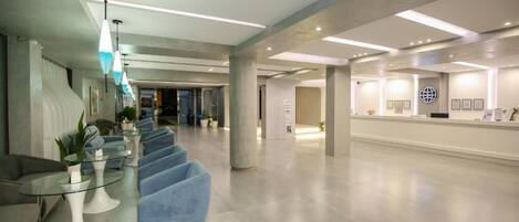 A spacious lobby with modern seating, a reception desk, and a clean, contemporary design.
