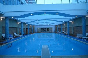 Indoor pool, open 8:00 AM to 10:00 PM, pool umbrellas, sun loungers