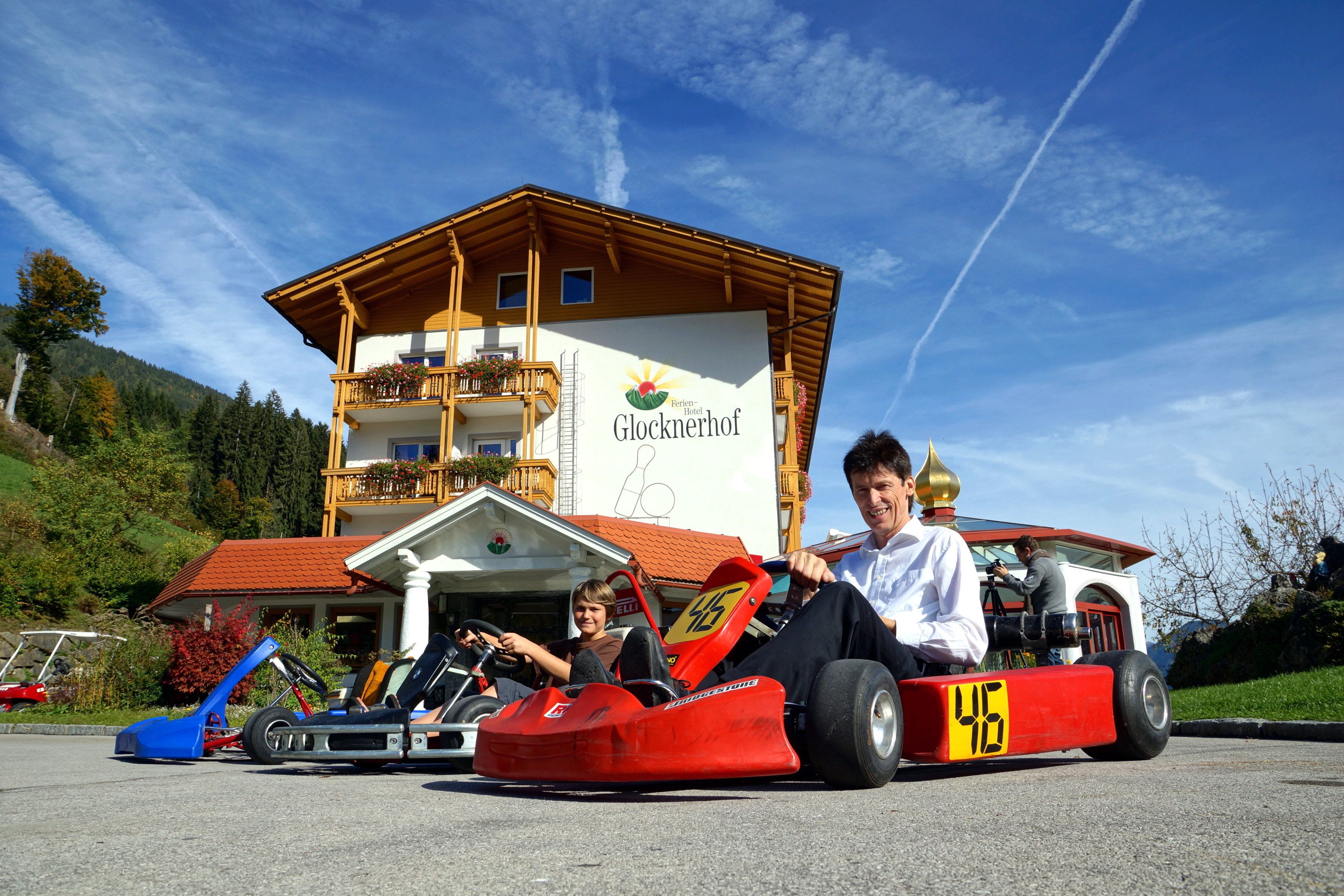 A building with a sign reading "Glocknerhof" and a red go-kart in front.
