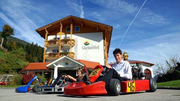 A building with a sign reading "Glocknerhof" and a red go-kart in front.