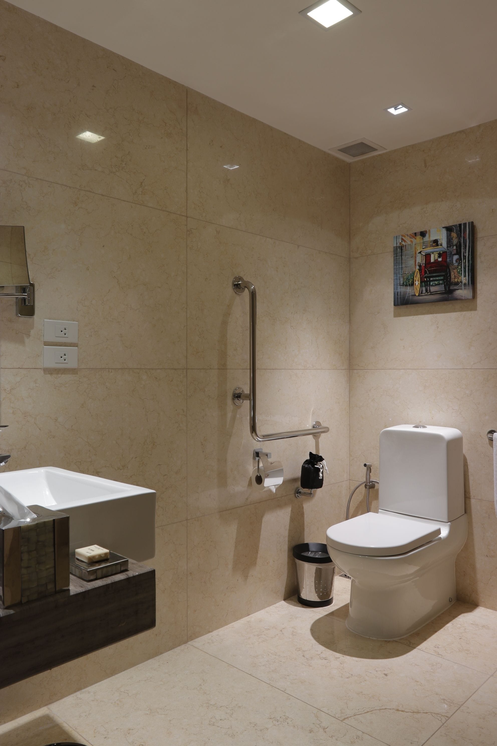 A modern bathroom with a toilet, bidet, and sink.