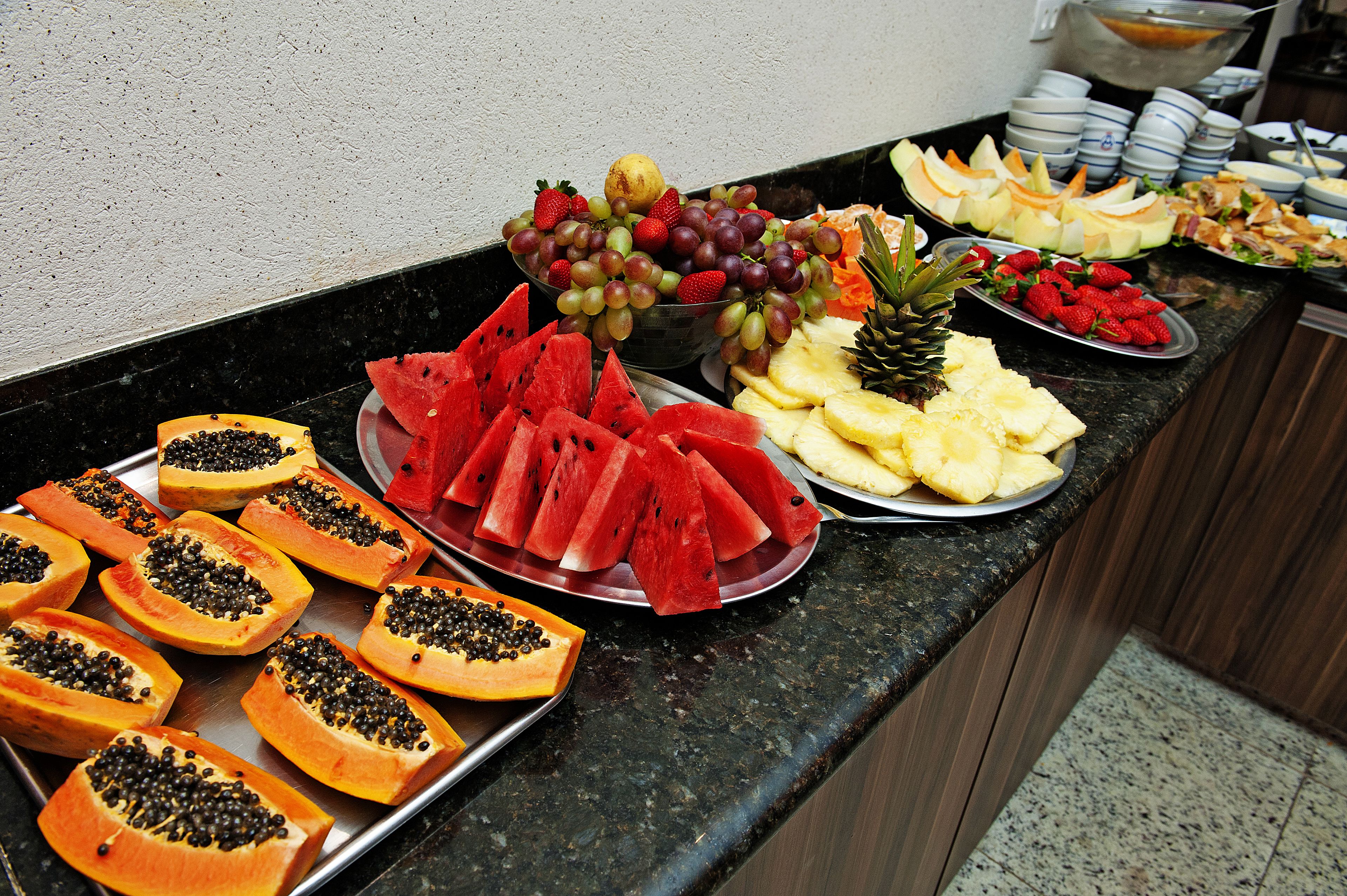 A buffet with various fruits and vegetables.