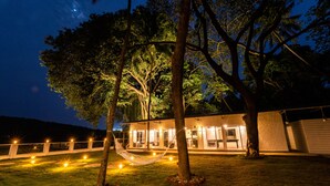 A house with a hammock in the yard, surrounded by trees and string lights. - Zone Connect by The Park Goa Calangute (Calangute)