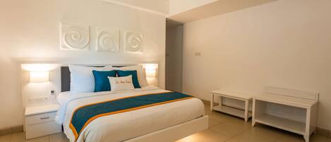 A modern bedroom with a large bed, bedside tables, and a nightstand.