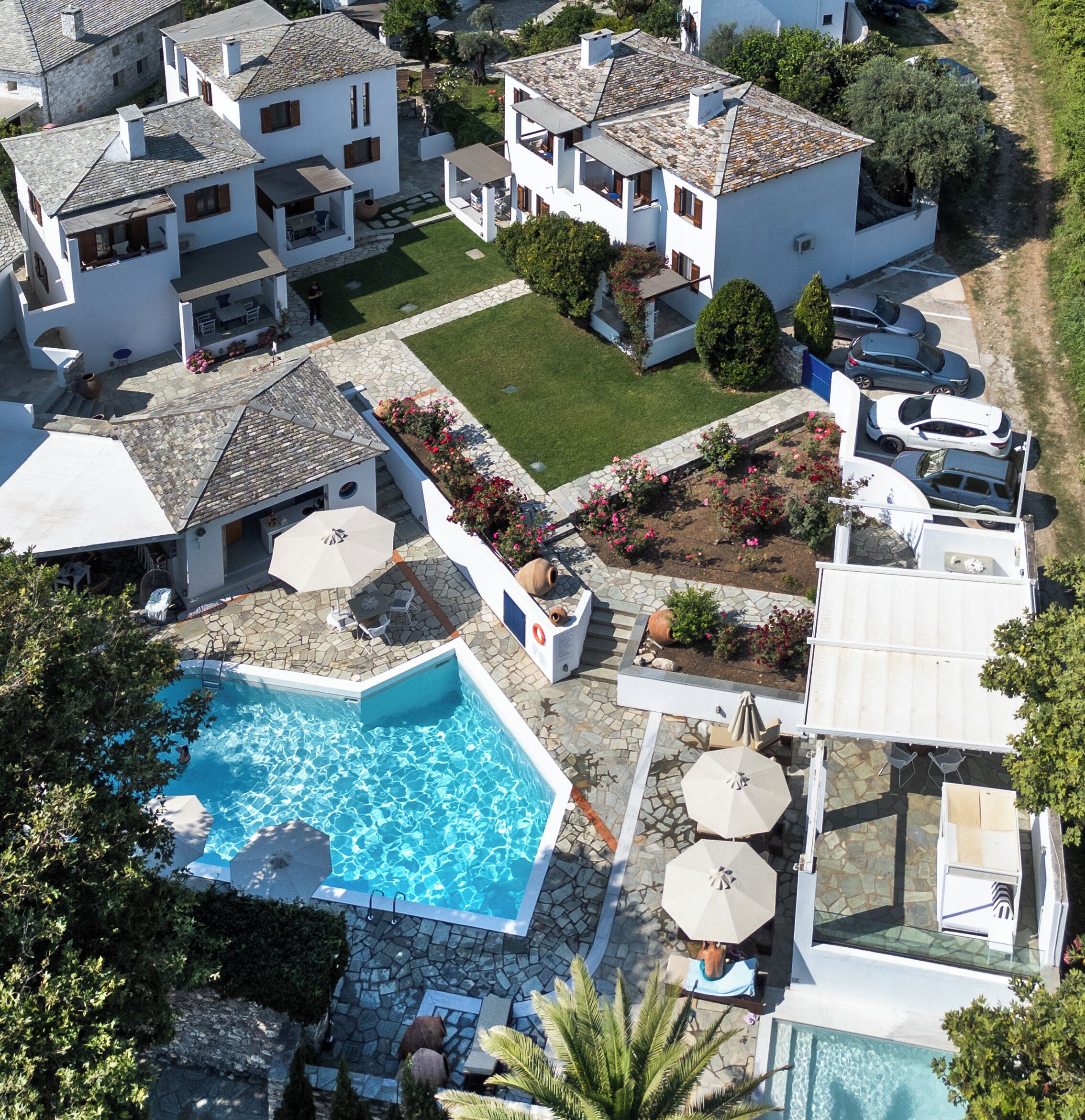 A residential area with multiple houses, a swimming pool, and a garden.