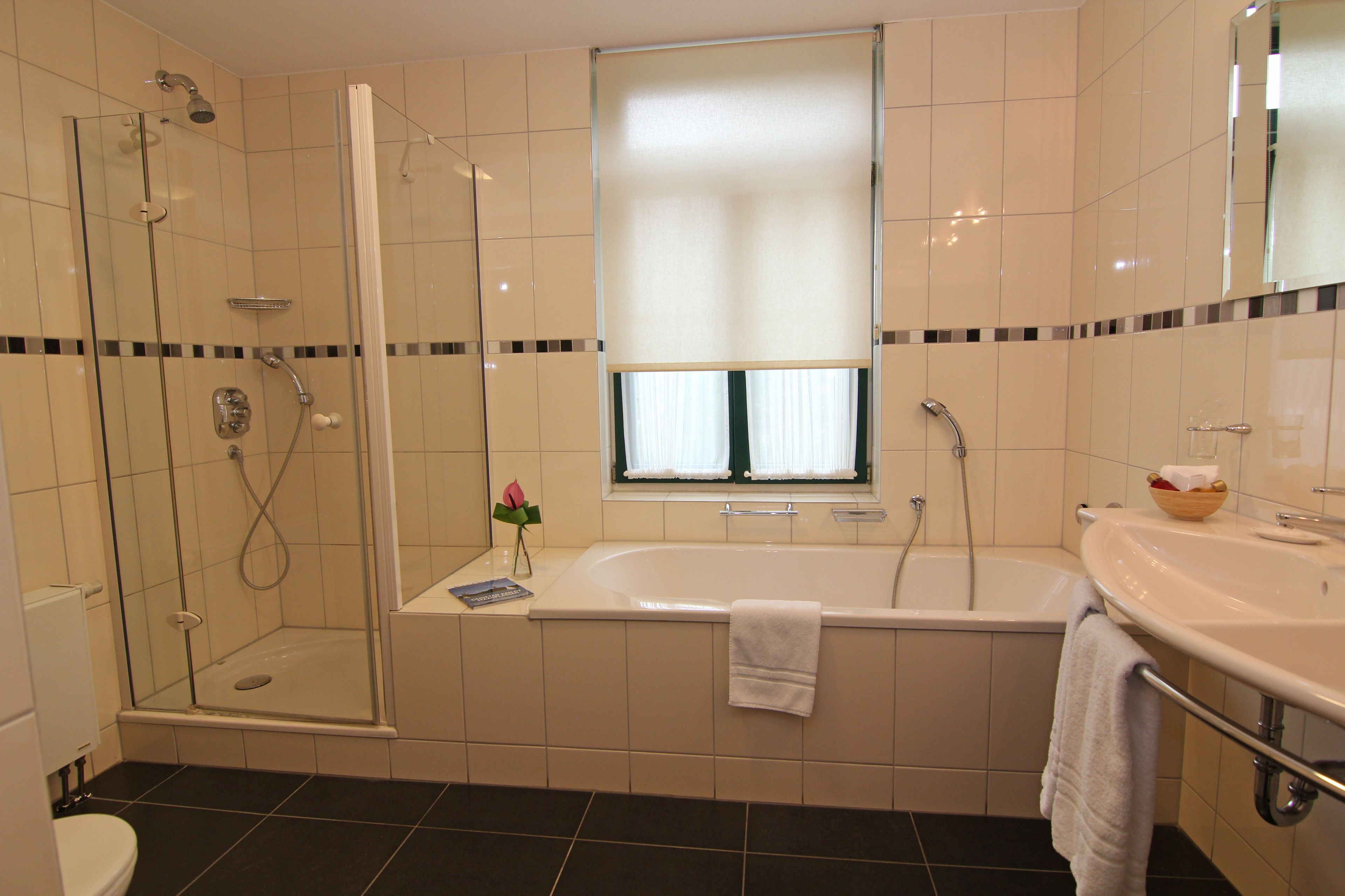 suite, garden view | bathroom | separate bathtub and shower, free toiletries, hair dryer, bathrobes
