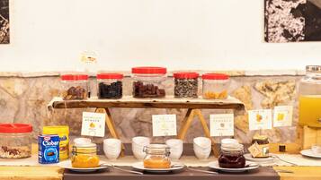 A breakfast buffet with various food items and condiments.