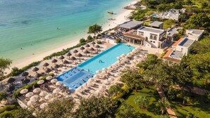 An aerial view of a resort with a swimming pool, beach, and ocean views. - Hotel Riu Palace Zanzibar - All Inclusive (Nungwi)