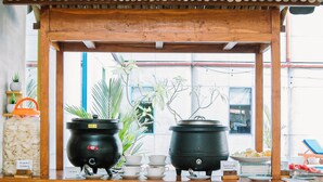 A wooden food cart with a sign reading "Morning Bite" and two black pots on wheels. - POP! Hotel Kuta Beach Bali (Kuta)