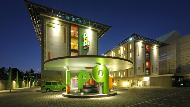 A hotel with a distinctive circular entrance and a prominent 'pop' sign. - POP! Hotel Kuta Beach Bali (Kuta)