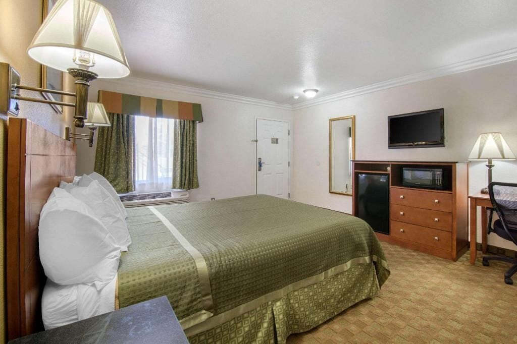 Desk, laptop workspace, blackout drapes, iron/ironing board