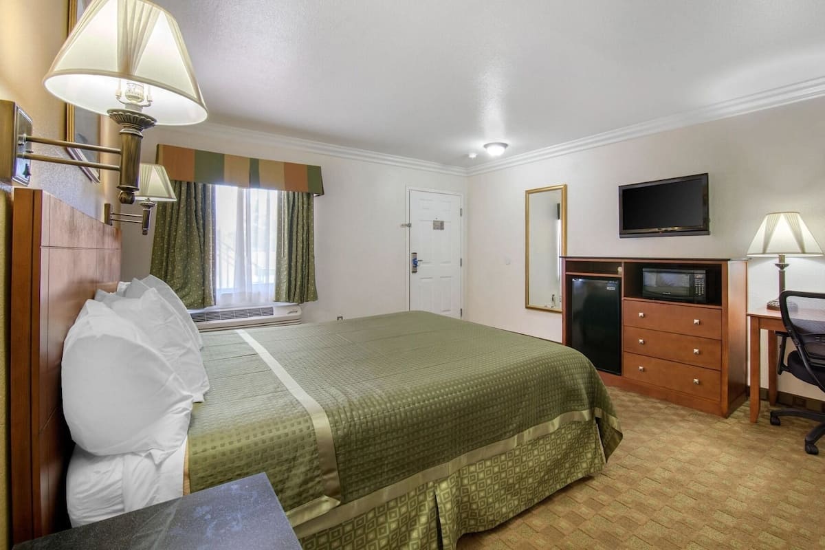 Desk, laptop workspace, blackout drapes, iron/ironing board