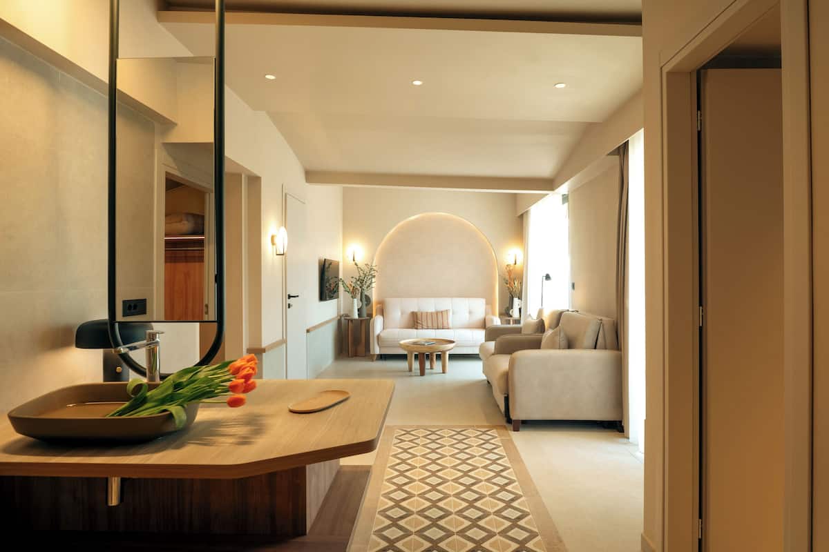 Un intérieur moderne comprenant un comptoir de cuisine, un coin repas et un salon avec un canapé et une table basse.