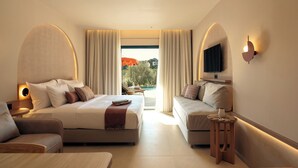 A modern hotel room with a bed, sofa, TV, and a view of the outdoors. - Zeus Eleva Kassandra Lagoon (Kassandra)