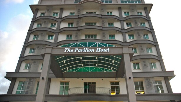 A multi-story hotel with a prominent sign reading "The Pavilion Hotel."