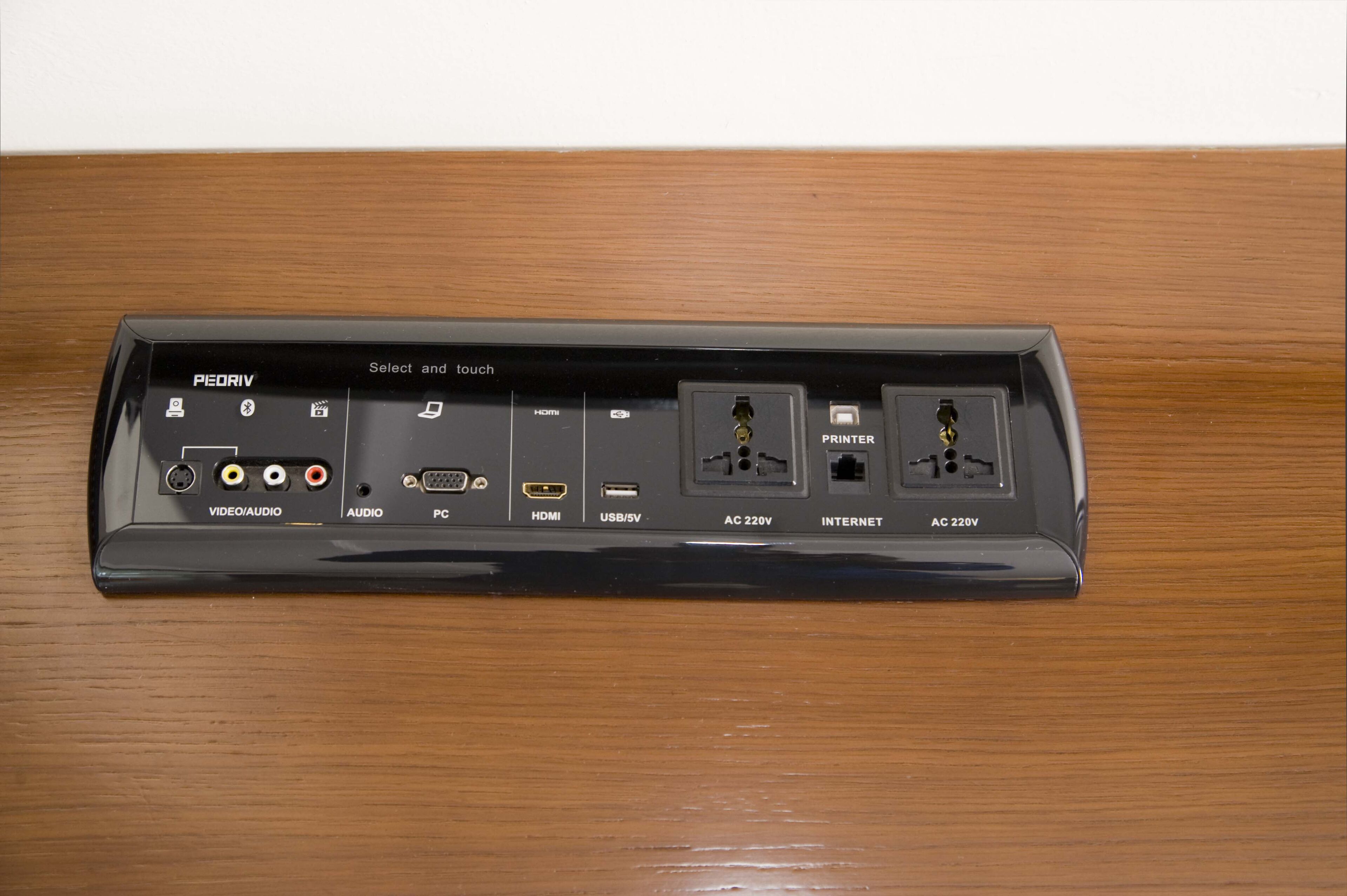 A black power strip with multiple ports including HDMI, USB, and AC outlets.