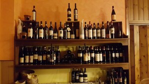 A wine cellar with multiple shelves stocked with various wine bottles. - La Lanterna (Chiesa in Valmalenco)