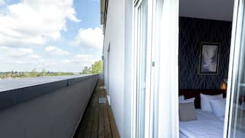 Enjoy a peaceful retreat with a balcony offering a serene view of the surrounding greenery.