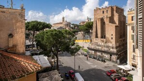 A cityscape with historic buildings, a prominent tower, and a clear sky. - Hotel Labelle  (Rome)