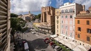 A street view with historic buildings, a castle-like structure, and a bar named 'MASSENZO BAR'. - Hotel Labelle  (Rome)