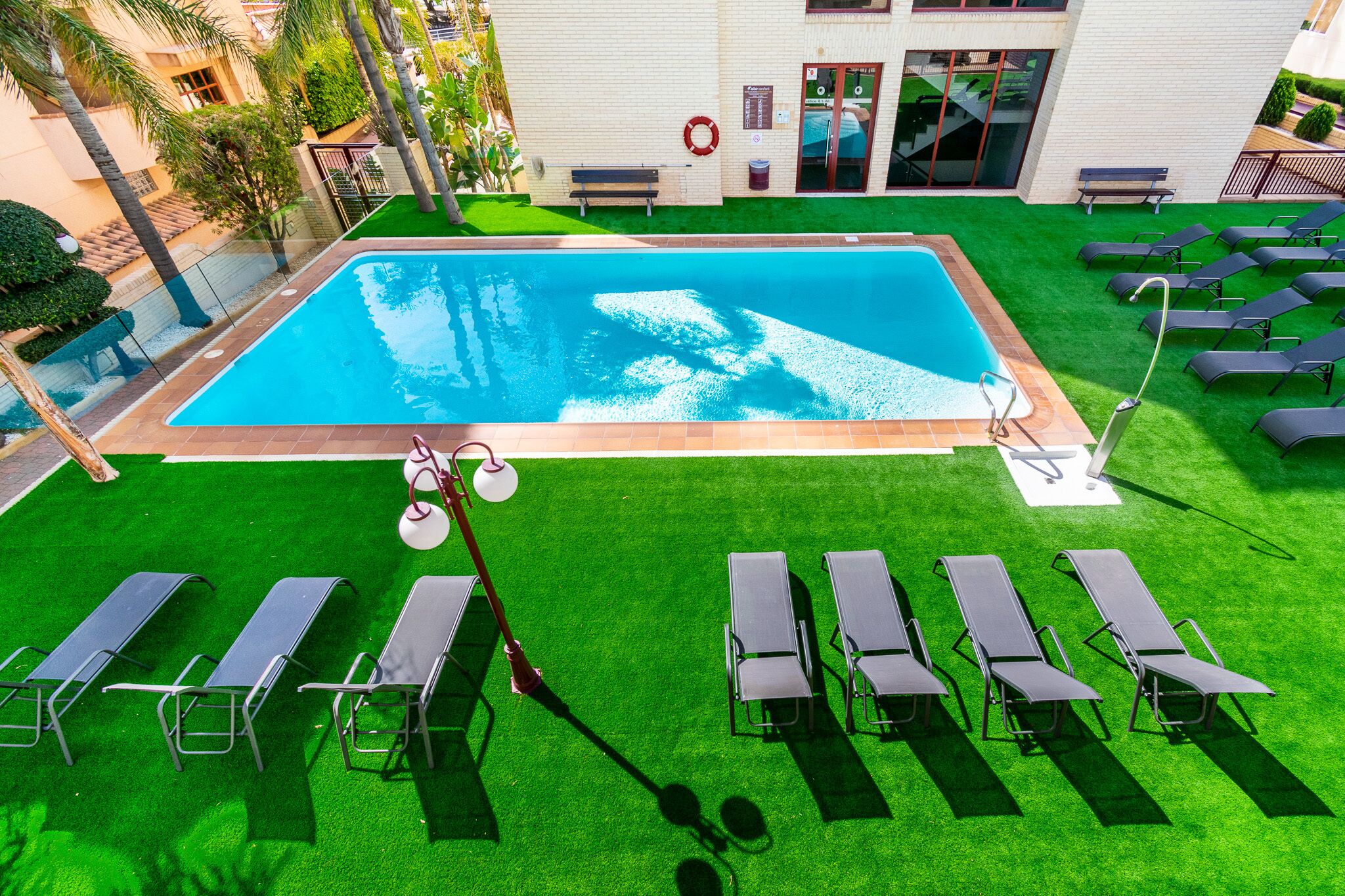 Outdoor pool, open 9 AM to 9 PM, pool loungers