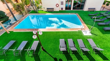 Outdoor pool, open 9 AM to 9 PM, pool loungers