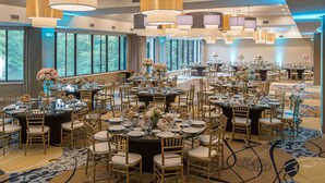 A large banquet hall with round tables, gold chairs, and floral centerpieces. - Holiday Inn Express Princeton Southeast by IHG (Plainsboro)
