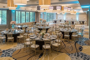 A large banquet hall with round tables, gold chairs, and floral centerpieces. - Holiday Inn Express Princeton Southeast by IHG (Plainsboro)