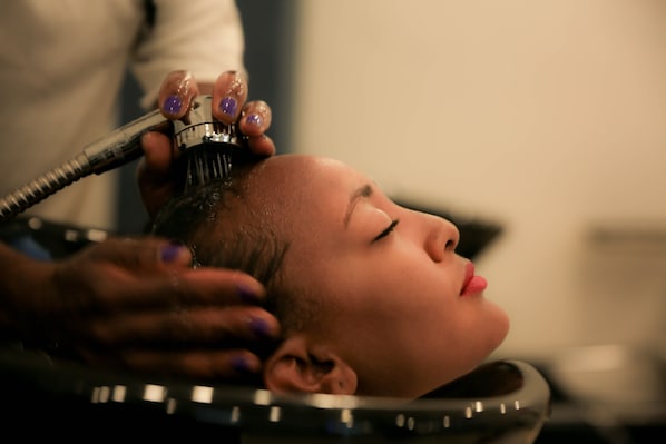 A person receiving a hair treatment.