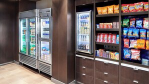 A vending area with multiple snack and drink options, including chips, cookies, and beverages. - Courtyard by Marriott Newark Downtown (Newark)