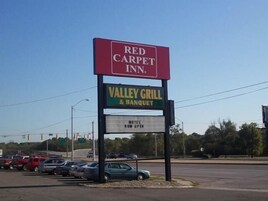 A sign for Red Carpet Inn and Valley Grill & Banquet.