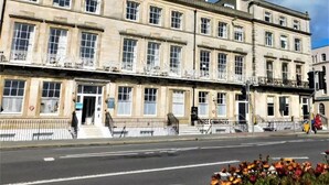 A multi-story building with a classic architectural style, featuring a series of windows and a central entrance. - The Jubilee Hotel West- with Spa Facilities (Weymouth)