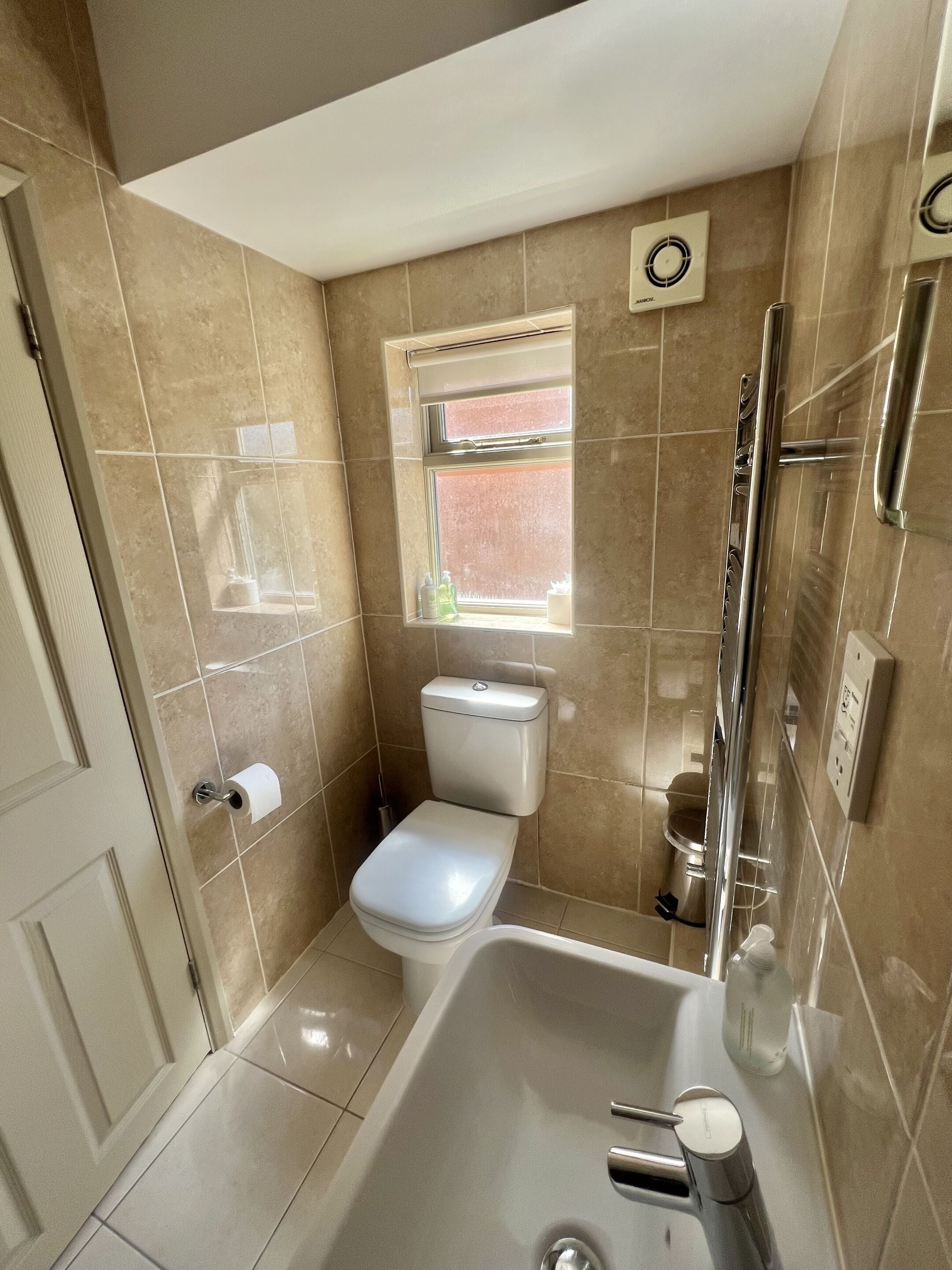 A bathroom with a toilet, sink, and shower.