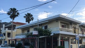 A two-story building with a sign for "neapolis" and "Filoxenia Studios".