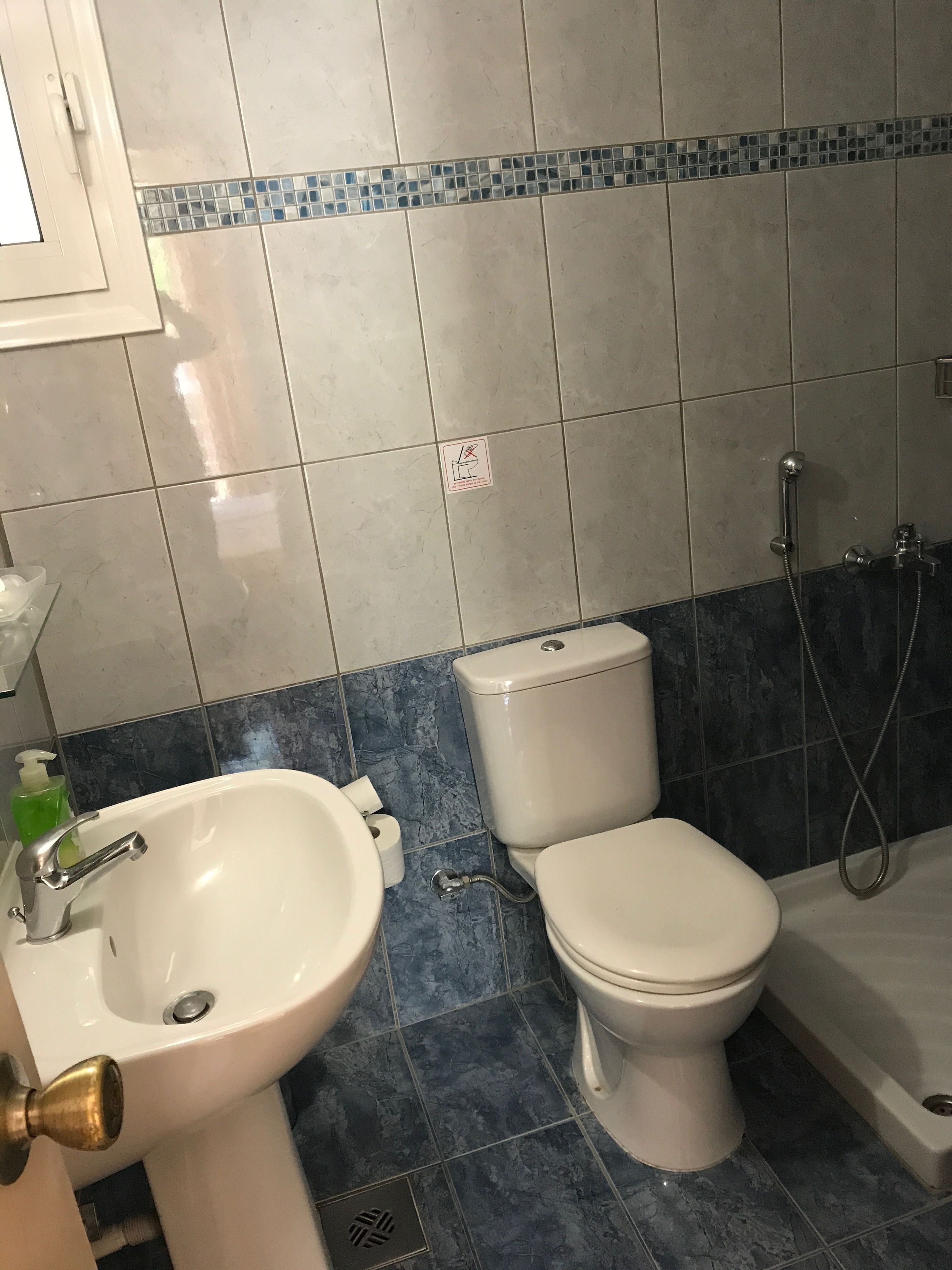 Een badkamer met een wastafel, toilet en bad.